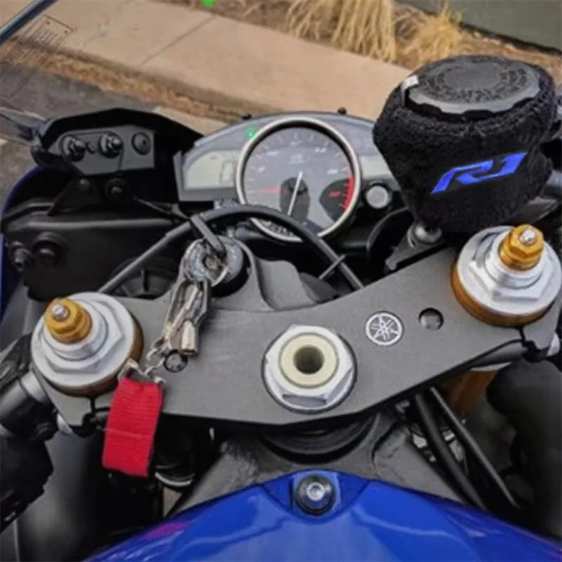 Close-up view of a black brake fluid reservoir cover sock for a Yamaha R1 R6 motorcycle.