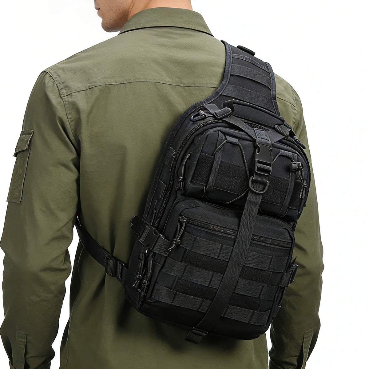 A person wearing a olive green shirt is holding a black Crossbody Chest Bag with multiple zipper compartments and a MOLLE sys