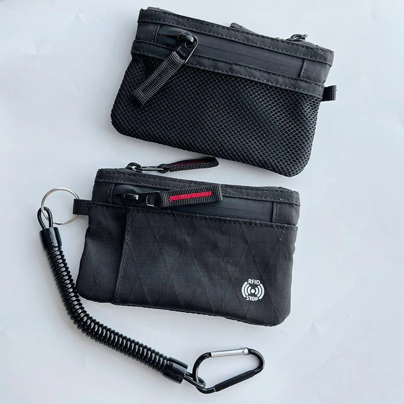 Black RFID-blocking travel wallet with a carabiner clip and RFID protection feature