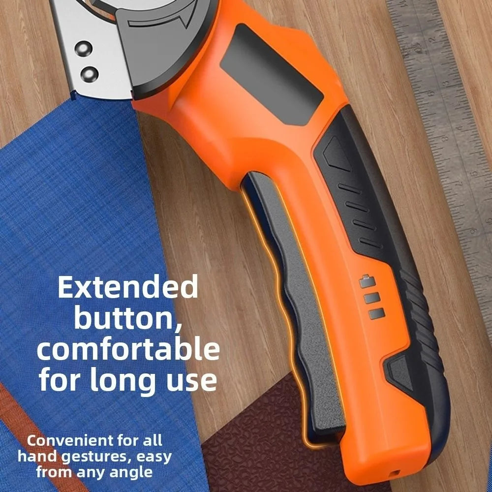 Orange cordless rotary scissors with an extended button shown on a wooden surface.