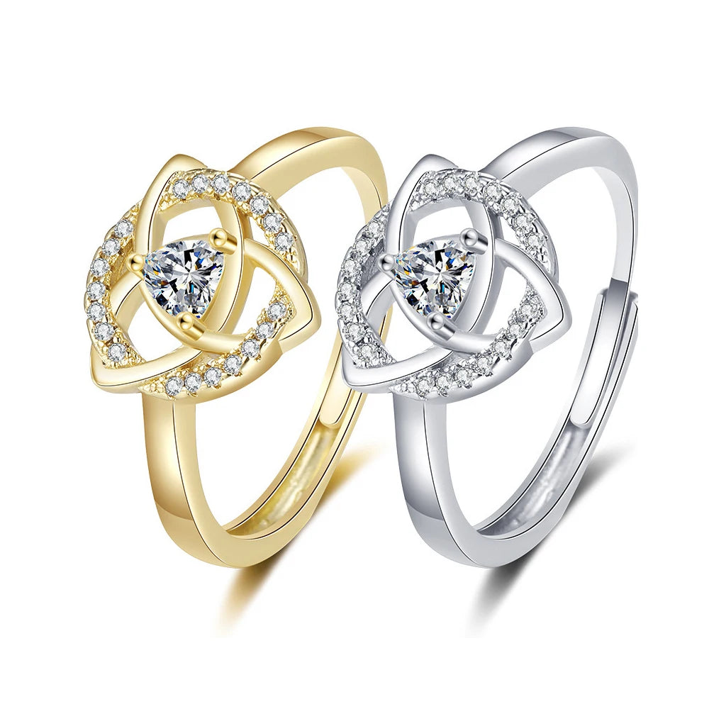 Gold and silver triquetra trinity knot rings featuring cubic zirconia stones