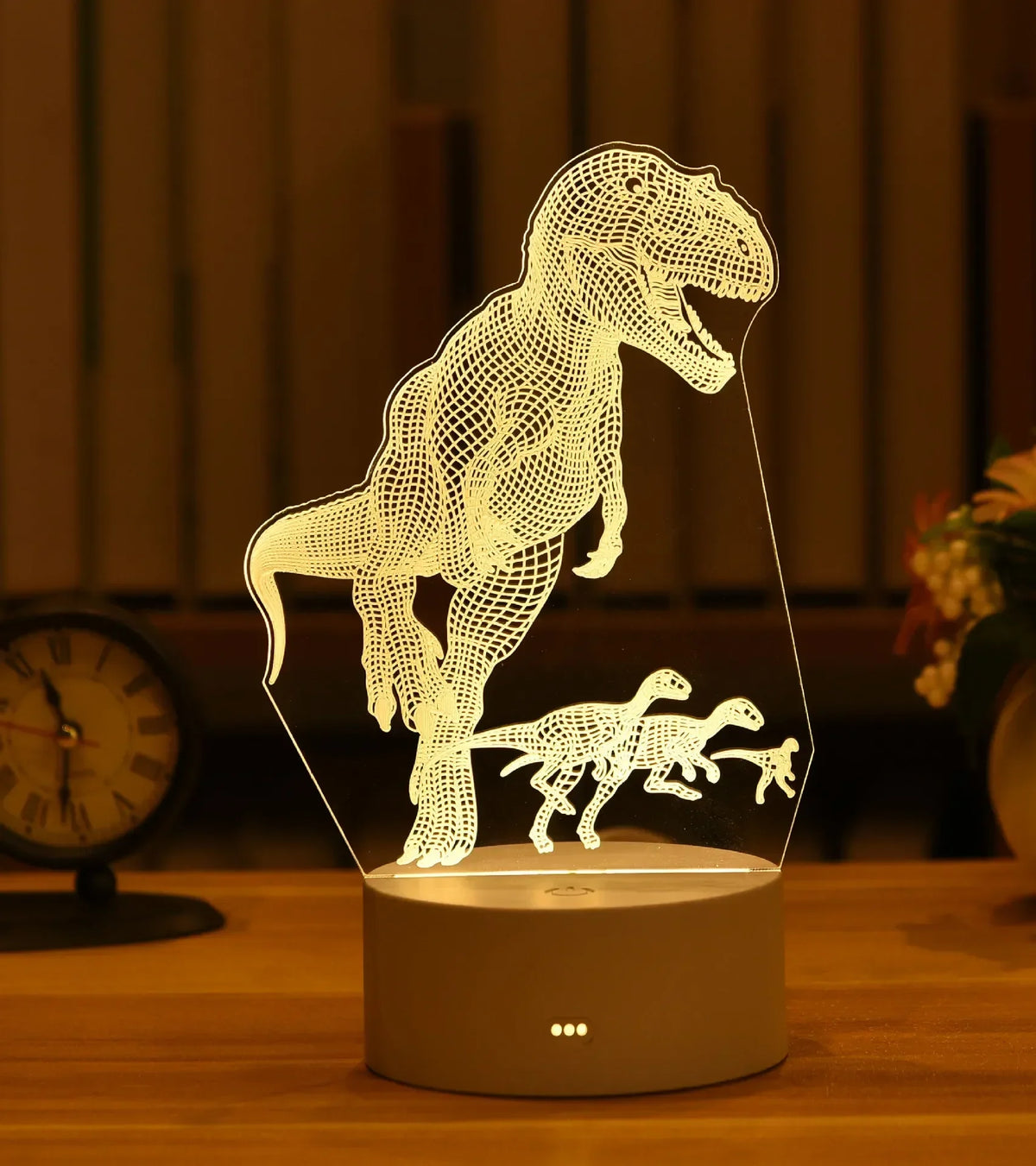 A glowing silhouette of a dinosaur is displayed on a clear acrylic base, functioning as an LED night light.