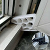 A white heavy-duty non-slip door stopper wedge is shown installed in a window frame.