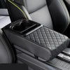 Black quilted car center console armrest cushion with a cup holder and textured upholstery