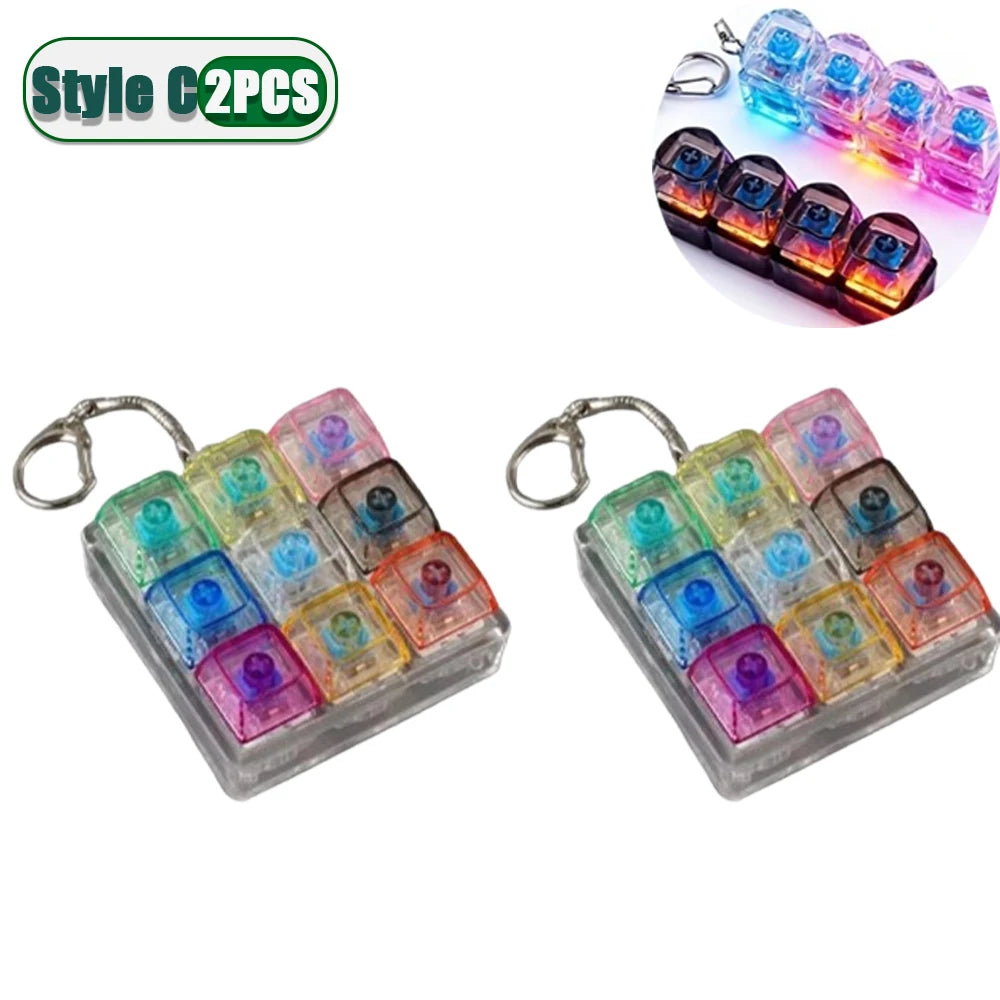 Two sets of colorful LED fidget keychains with a keyboard design and metal clasps.