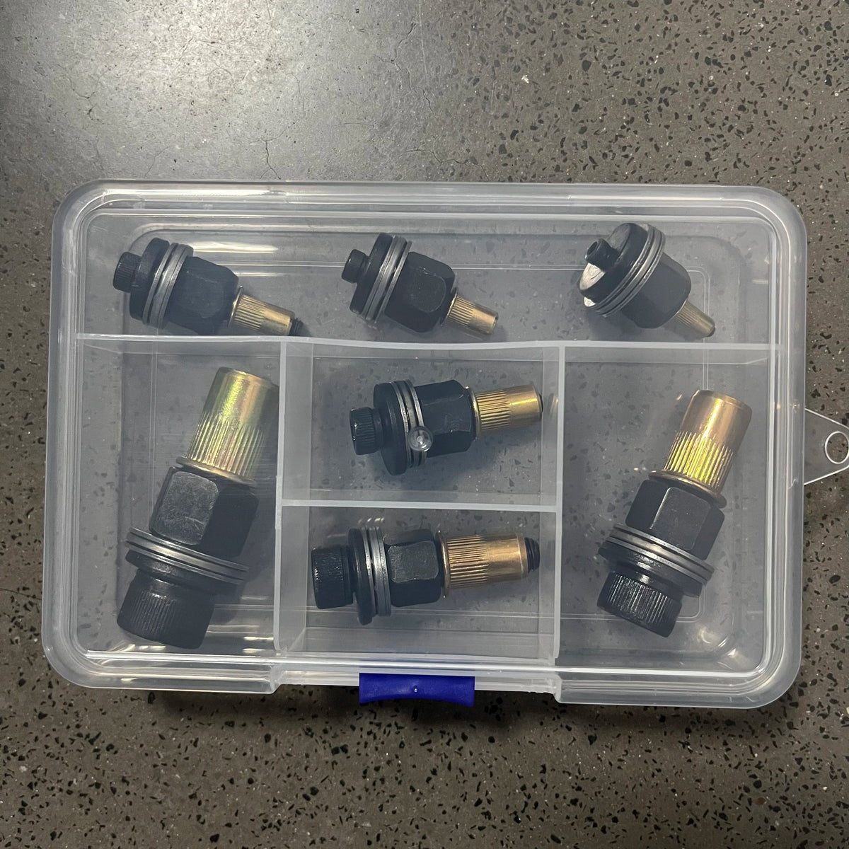 A clear plastic container holds a 7-piece rivnut insert tool kit with mandrels for M3 to M12 sizes.