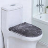A white toilet features a gray flannel seat cover placed on the seat.