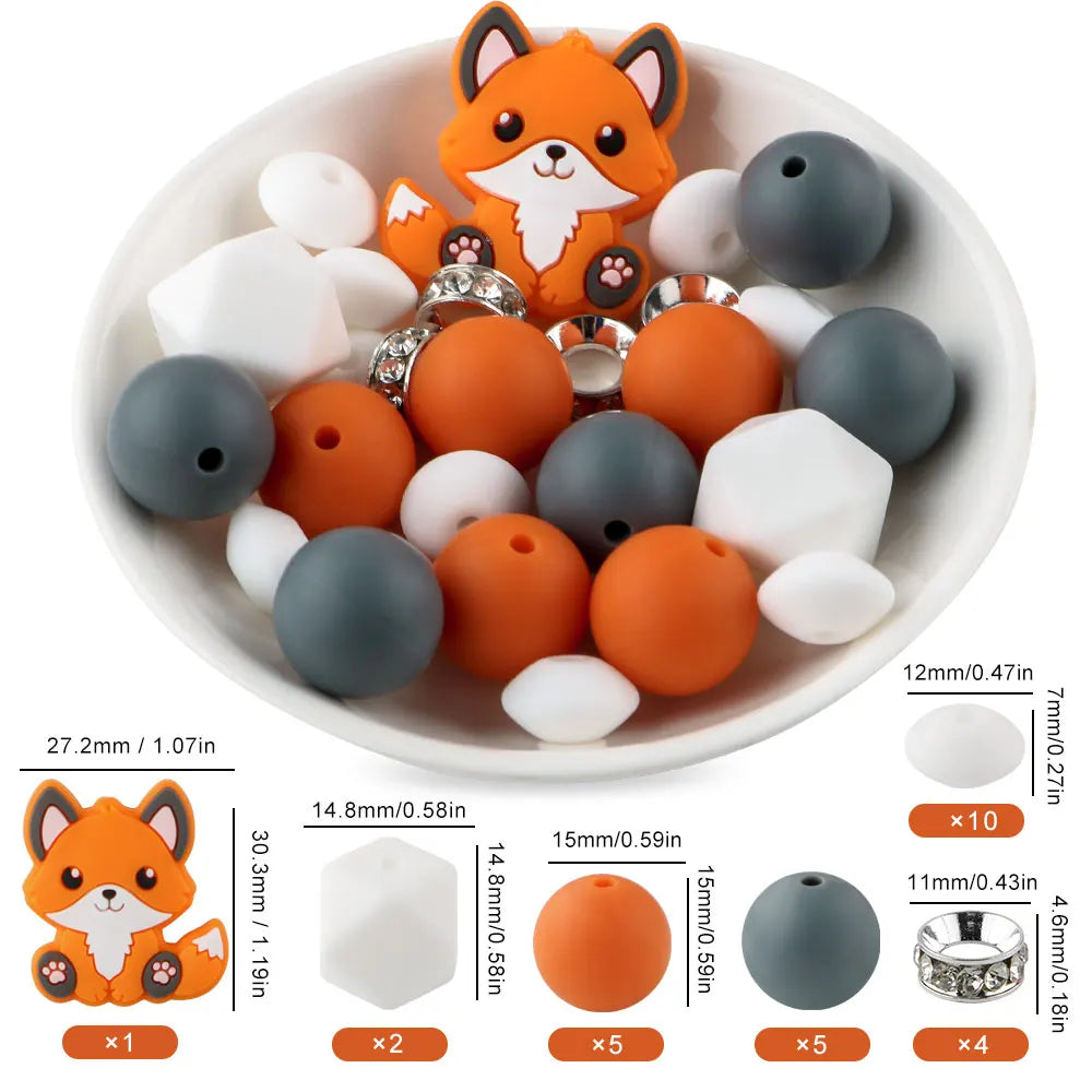 A collection of orange and gray silicone focal beads shaped like foxes, including round and irregular pieces for jewelry maki