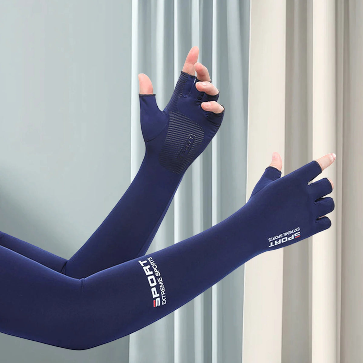 A close-up of a navy blue ice silk UV protection arm sleeve being worn on a hand and forearm.