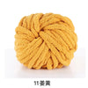 A ball of chunky yellow acrylic yarn used for knitting and crochet