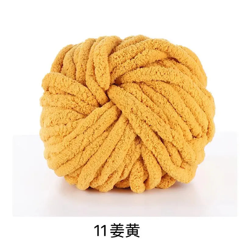 A ball of chunky yellow acrylic yarn used for knitting and crochet