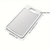 A white non-slip laundry scrubbing board with ridges and a handle, shown from above.