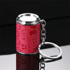 A shiny silver metal coin tube keychain with a pink textured body and a circular ring.