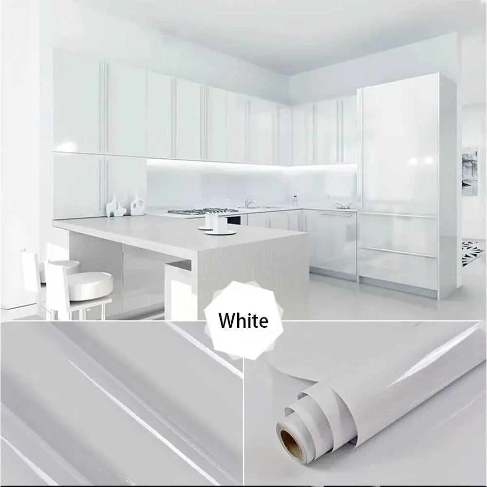 White marble peel-and-stick film used as a kitchen backsplash in a modern white kitchen.
