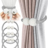 Pearl magnetic curtain tiebacks in gray and white, showing how they secure fabric.
