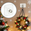 A self-adhesive stainless steel wall hook is shown hanging on a Christmas wreath decorated with lights and ornaments.