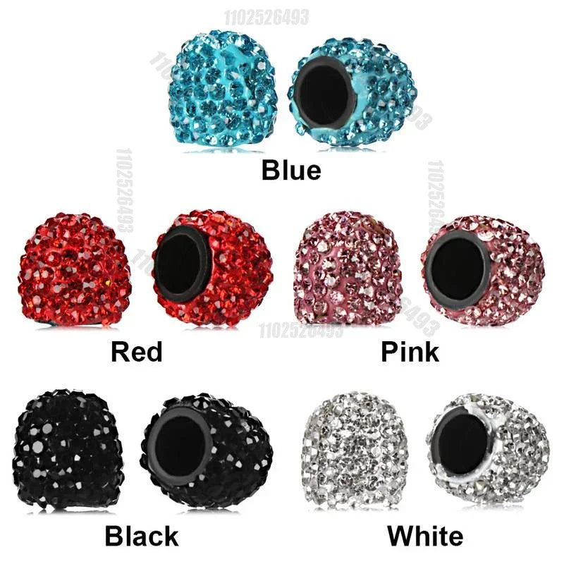 A collection of crystal-cut tire valve caps in blue, red, pink, black, and white.
