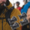 Close-up of a yellow jacket showing multiple black rotatable hydration tube clips attached to the strap.