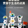 A set of handcrafted astronaut figurines made of resin, featuring various poses and colors, displayed on a dark surface.