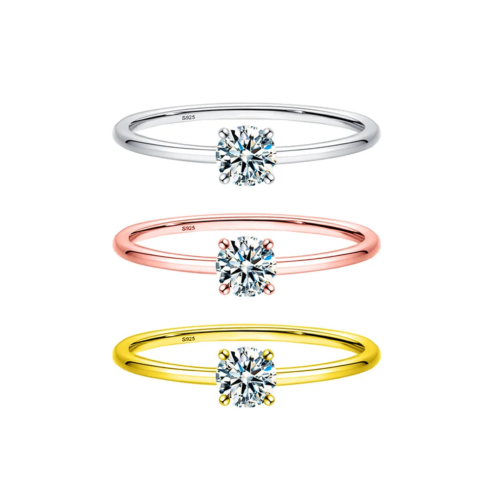 A minimalist moissanite solitaire ring shown in sterling silver, featuring a brilliant clear stone.