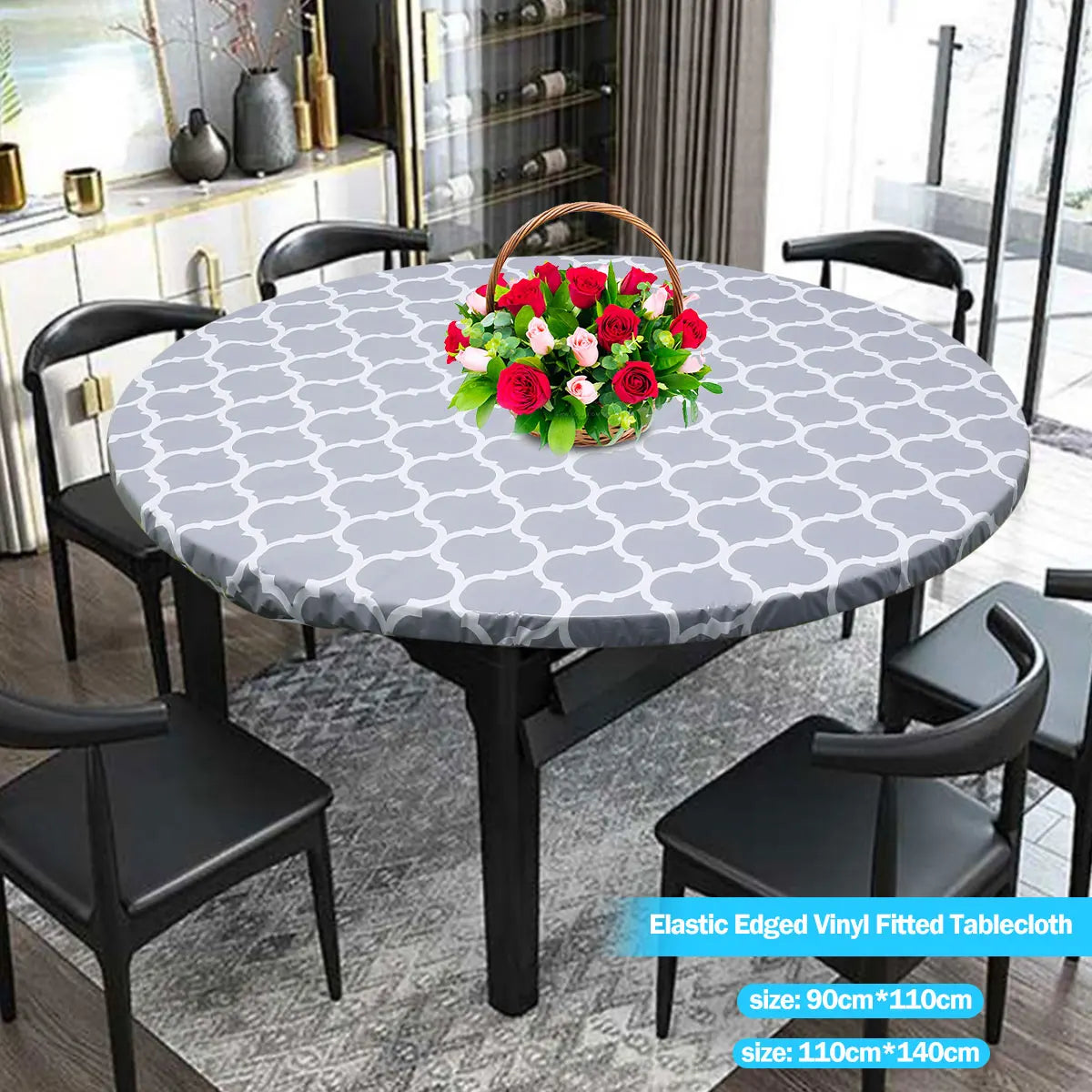 A round table set featuring a gray and white patterned elastic-edged vinyl tablecloth with black chairs.