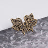 A vintage brass butterfly-shaped no-sew adjustable waist tightener for jeans and skirts.