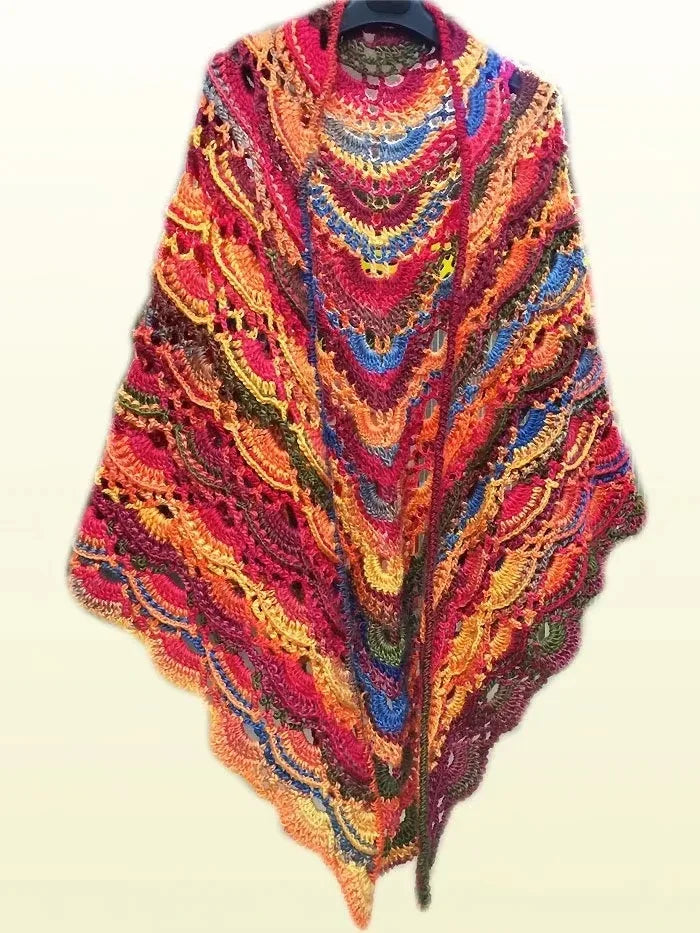 A vibrant, gradient dyed wool blend yarn displayed draped around a hanger.