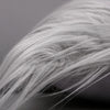 Close-up of silver and gold sequin fur fabric showing soft, wispy texture.