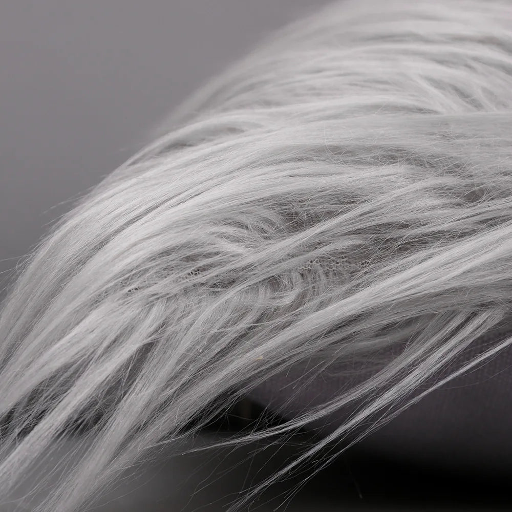 Close-up of silver and gold sequin fur fabric showing soft, wispy texture.