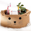 A woven cotton rope storage basket shaped like a fox head holding weekly planner paper and pens.