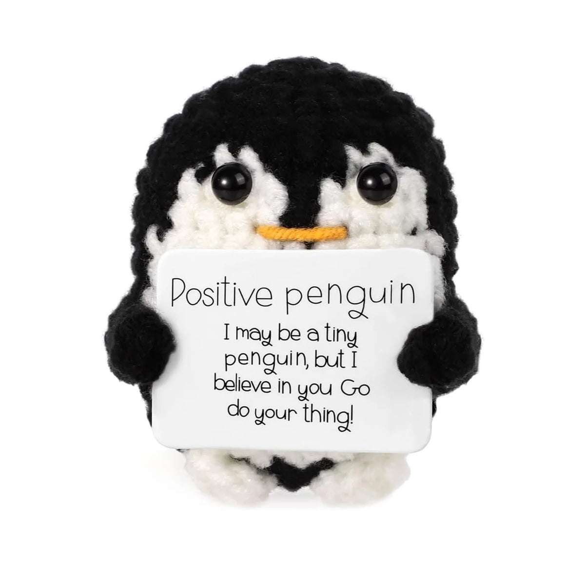 A handmade knitted penguin doll with a card featuring the text Positive penguin I may be a tiny penguin but I believe in you 