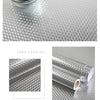 Roll of brushed silver peel-and-stick metal wallpaper showing a textured pattern on a white background.