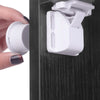 A hand is shown inserting a white magnetic cabinet lock into a dark cabinet drawer.