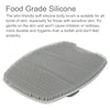 A gray silicone body brush with numerous small, rounded bristles shown from above.