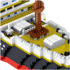 A close-up view of a large building block model kit depicting a ship structure with various gray, white, and brown components