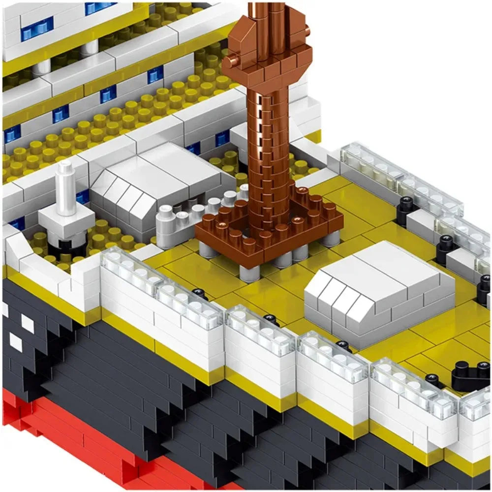A close-up view of a large building block model kit depicting a ship structure with various gray, white, and brown components