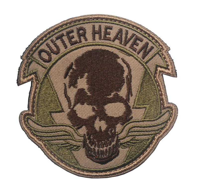 Embroidered patch featuring a skull design and the text OUTER HEAVEN on a fabric background.