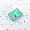 A green box of Let's Get Drunk cards with various text prompts and illustrations for a drinking game.