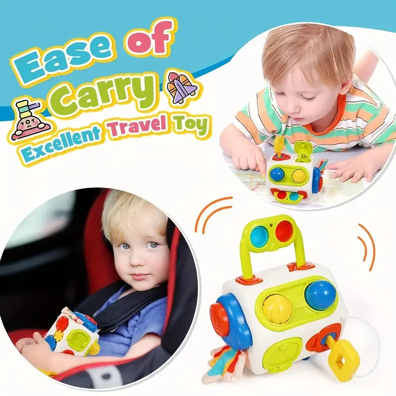 A yellow and blue Montessori busy cube sensory learning toy is shown being held by a toddler.