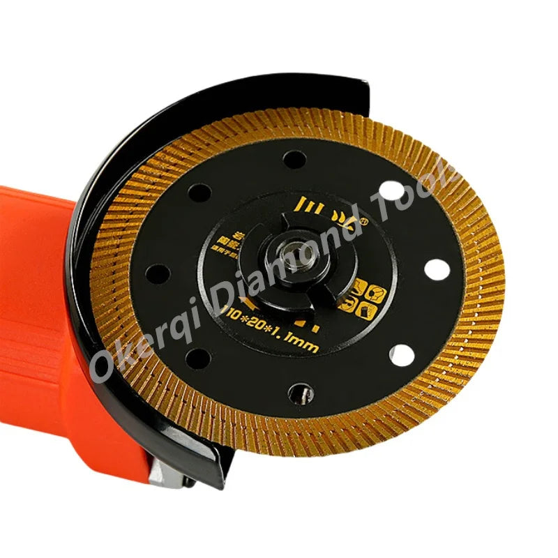 A black turbo diamond saw blade with a gold-colored edge and an orange handle.