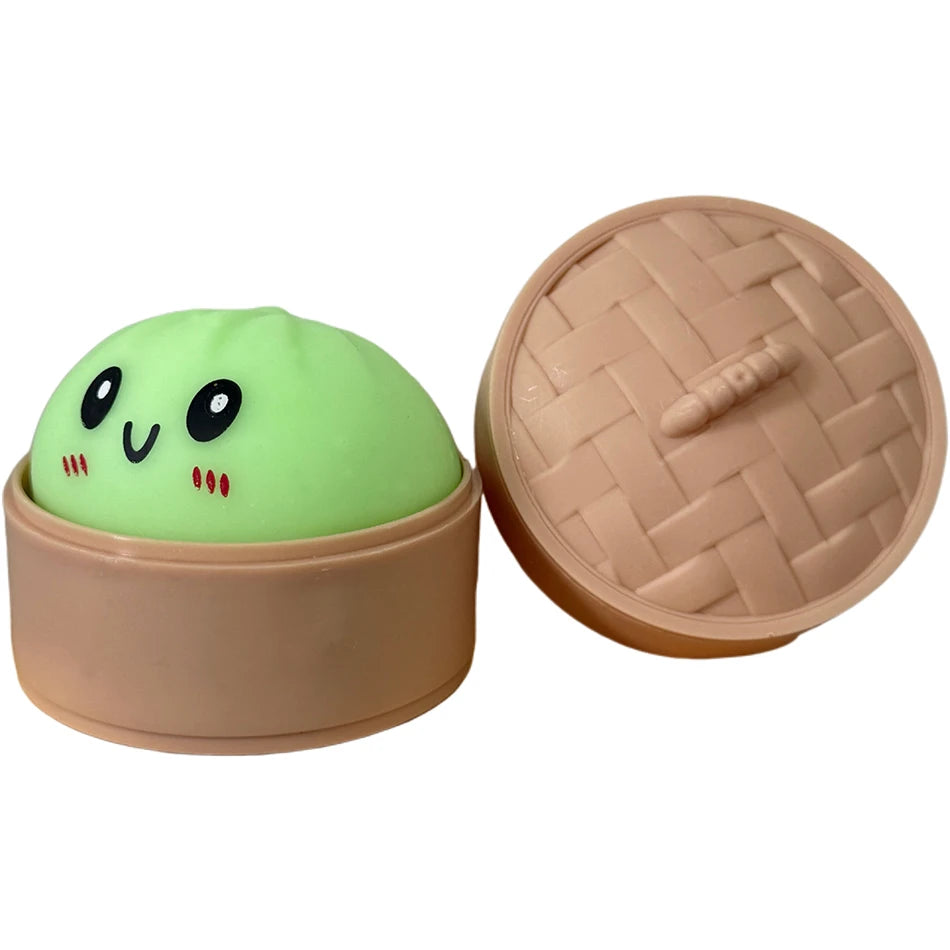 Hellgrüner, quetschbarer Dumpling-Sensorspielzeug mit Deckel in passender beige Box.