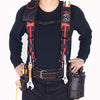 A person wearing a black shirt and pants is shown with a heavy duty padded tool belt and suspenders.