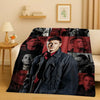 A dark flannel throw blanket featuring multiple portraits of characters from the Supernatural TV show