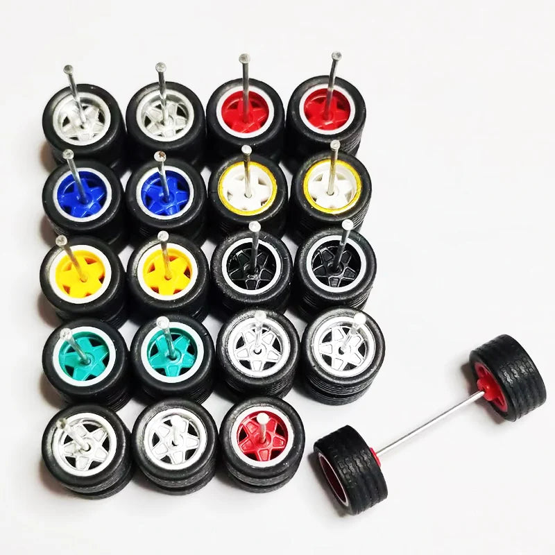 Ten pairs of 1:64 scale alloy car wheels and tires in various colors are arranged on a white background.
