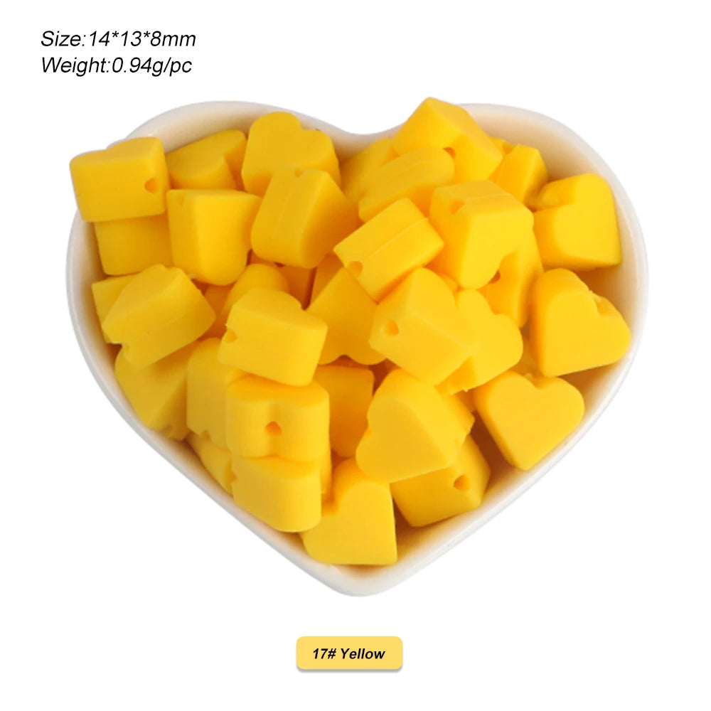 A pile of yellow silicone crown star heart beads for DIY jewelry making