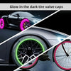 Close-up of a car wheel with glow-in-the-dark valve caps visible on the tire and rim.