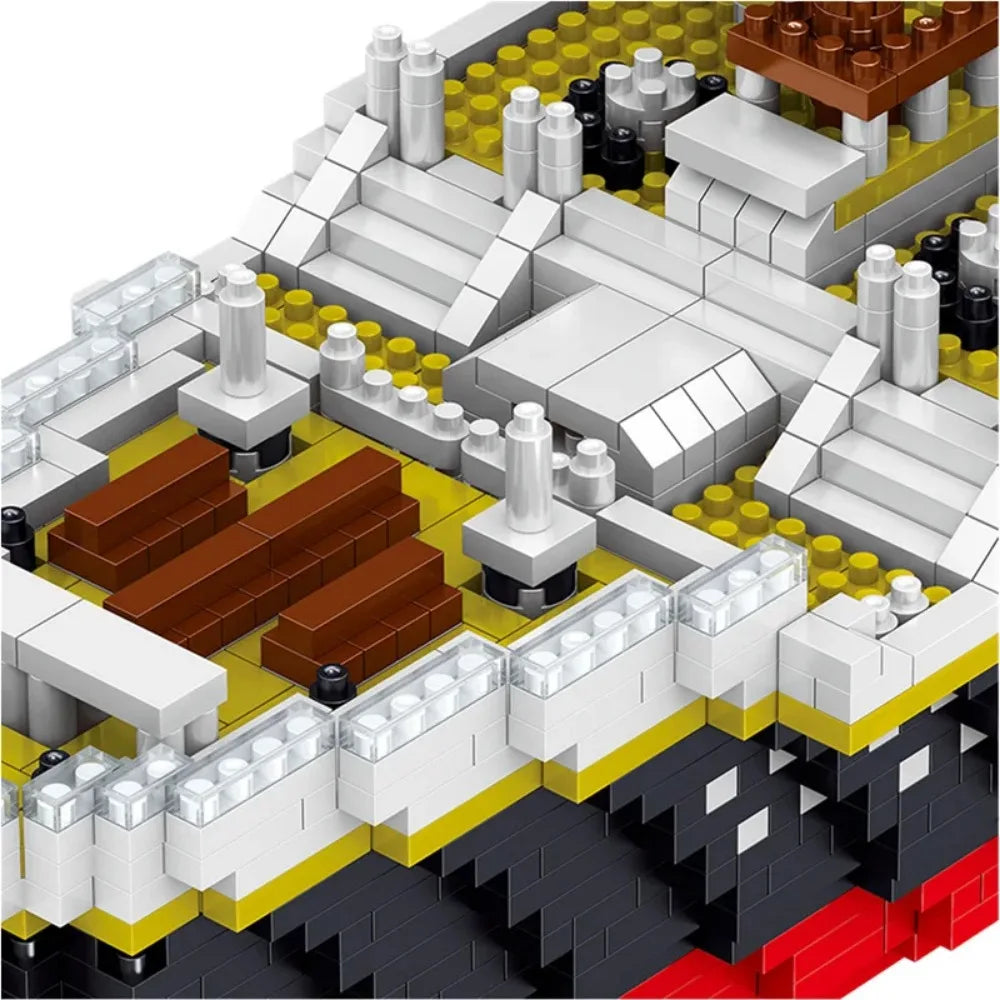 A close-up view of a large model kit built from interlocking plastic bricks, showing various white, yellow, brown, and black 