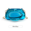 A small, glossy blue metal clutch bag with gold accents.