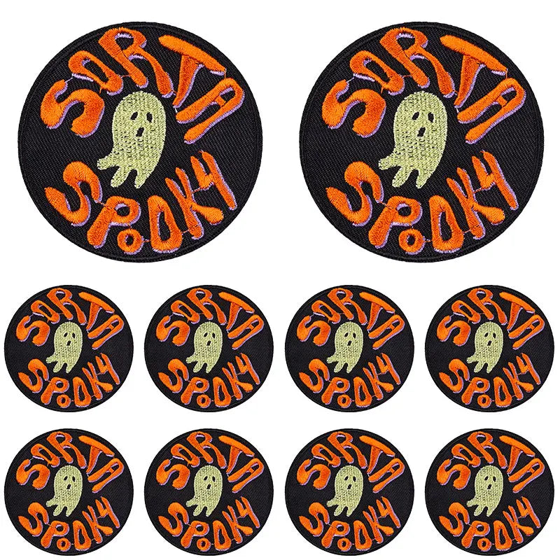 A set of ten black embroidered iron-on patches featuring an orange punk skull and spooky text.