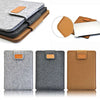A set of felt laptop sleeves in gray, black, and brown with leather accents shown in various angles.
